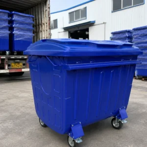 Blue Metal Four-Wheel Waste Container Export Loading Blue metal four-wheel waste container prepared for bulk export loading at a factory