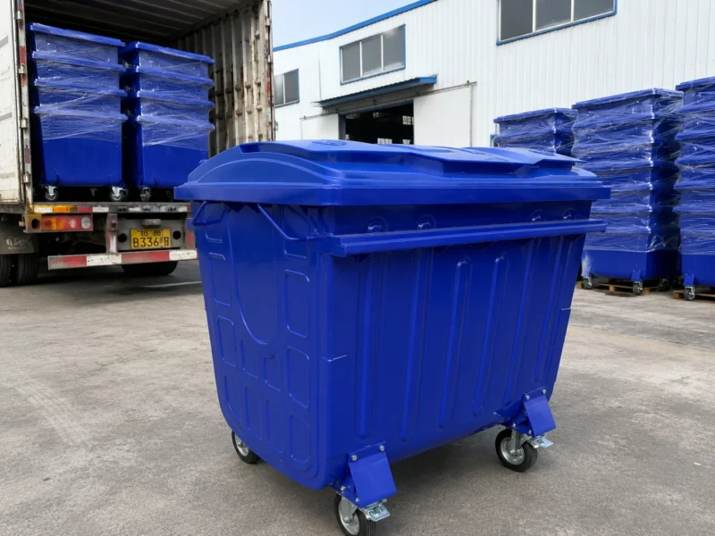 Blue Metal Four-Wheel Waste Container Export Loading Blue metal four-wheel waste container prepared for bulk export loading at a factory