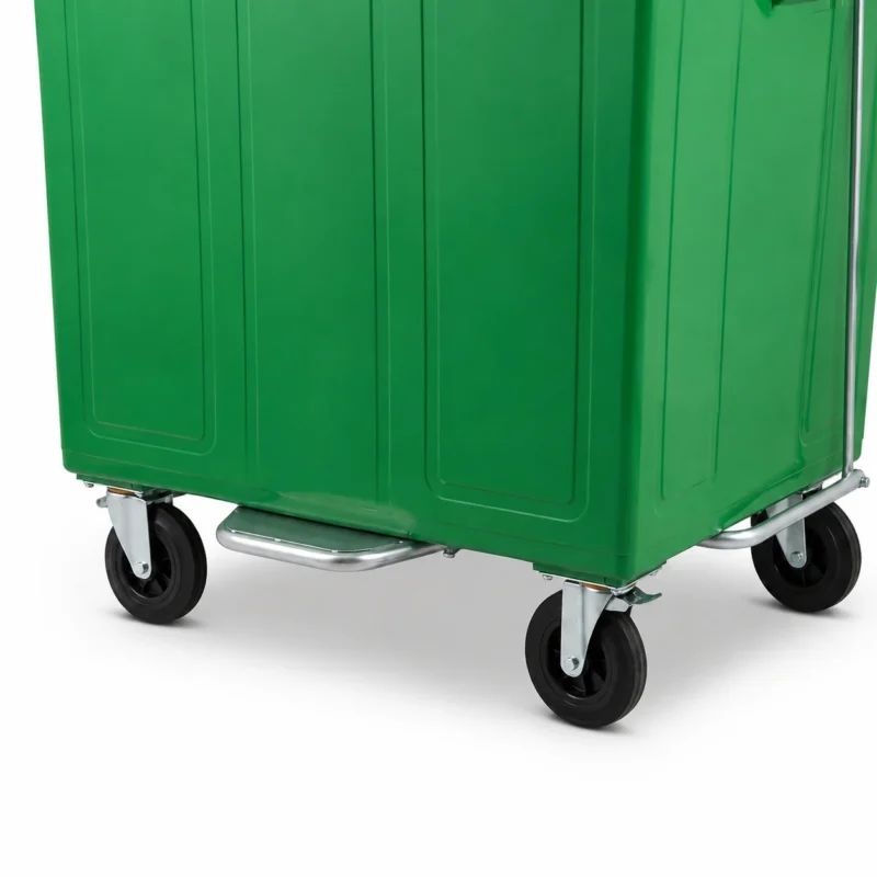 Close-up of caster wheels and foot pedal system on a 1100L green metal waste container