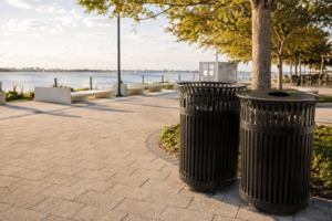 Durable outdoor waste bins on a waterfront public promenade